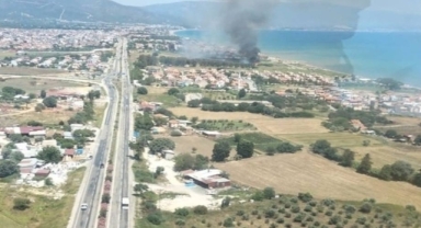 Seferihisar'da sazlık alanda yangın çıktı: Söndürme çalışmaları sürüyor 